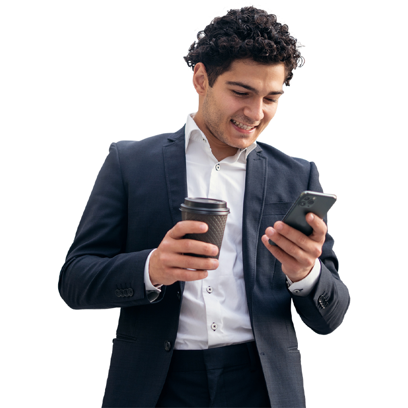 Man in suit holding coffee and phone