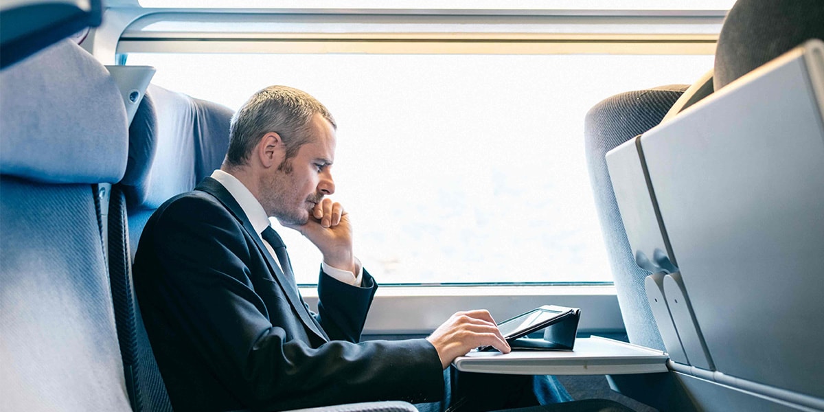 man sitting on train contemplating