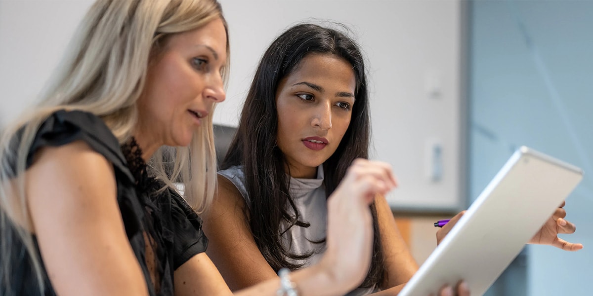 two colleagues working together on laptop