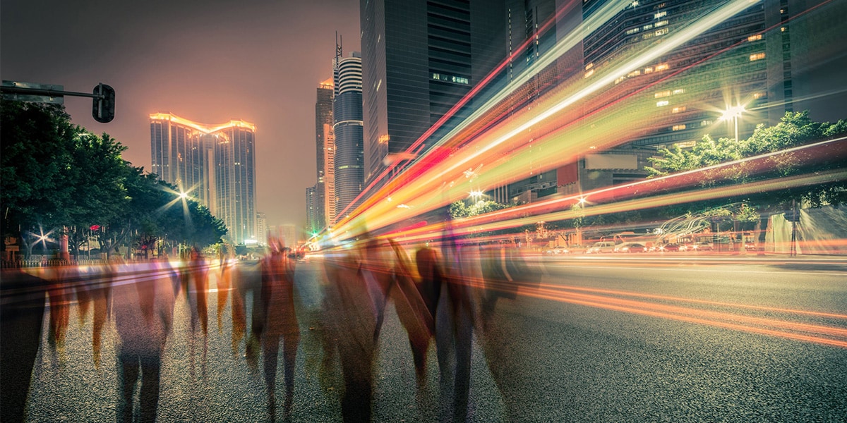 people walking on the street with city lights