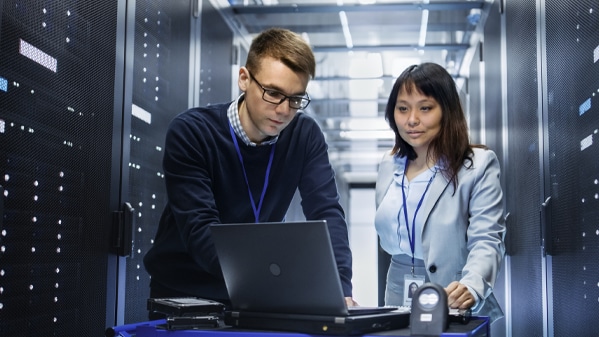 Two people working on a computer system