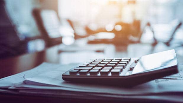 Calculator sitting on top of some papers