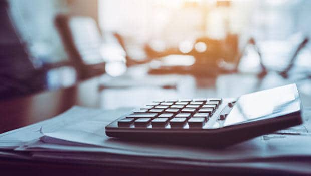 Calculator sitting on top of some papers