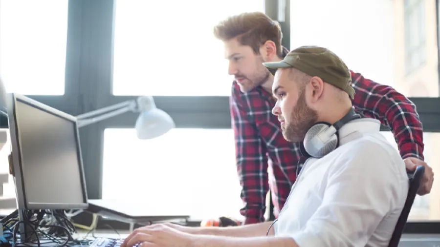 Two people working together on a computer