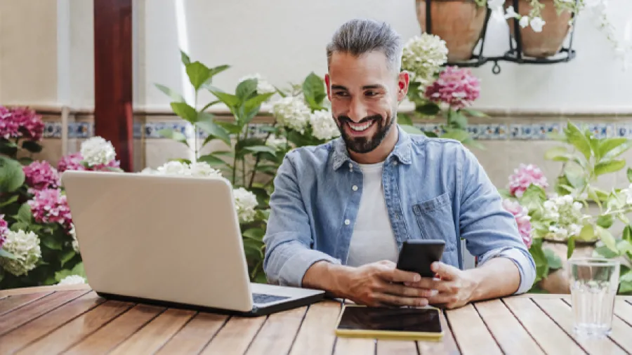 Man working on computer and phone