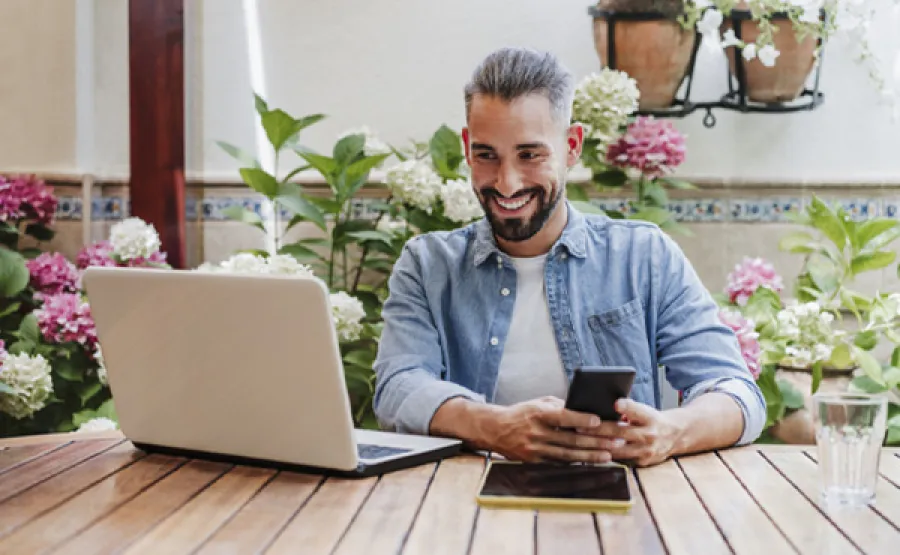 business professional at desk with devices
