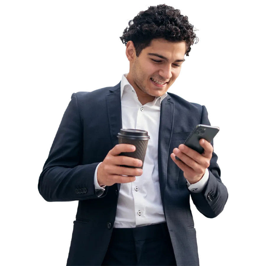 Man in suit holding coffee and phone