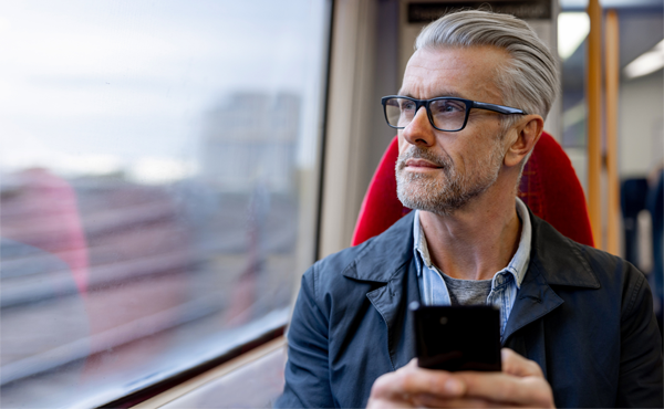 man working on phone while on a train