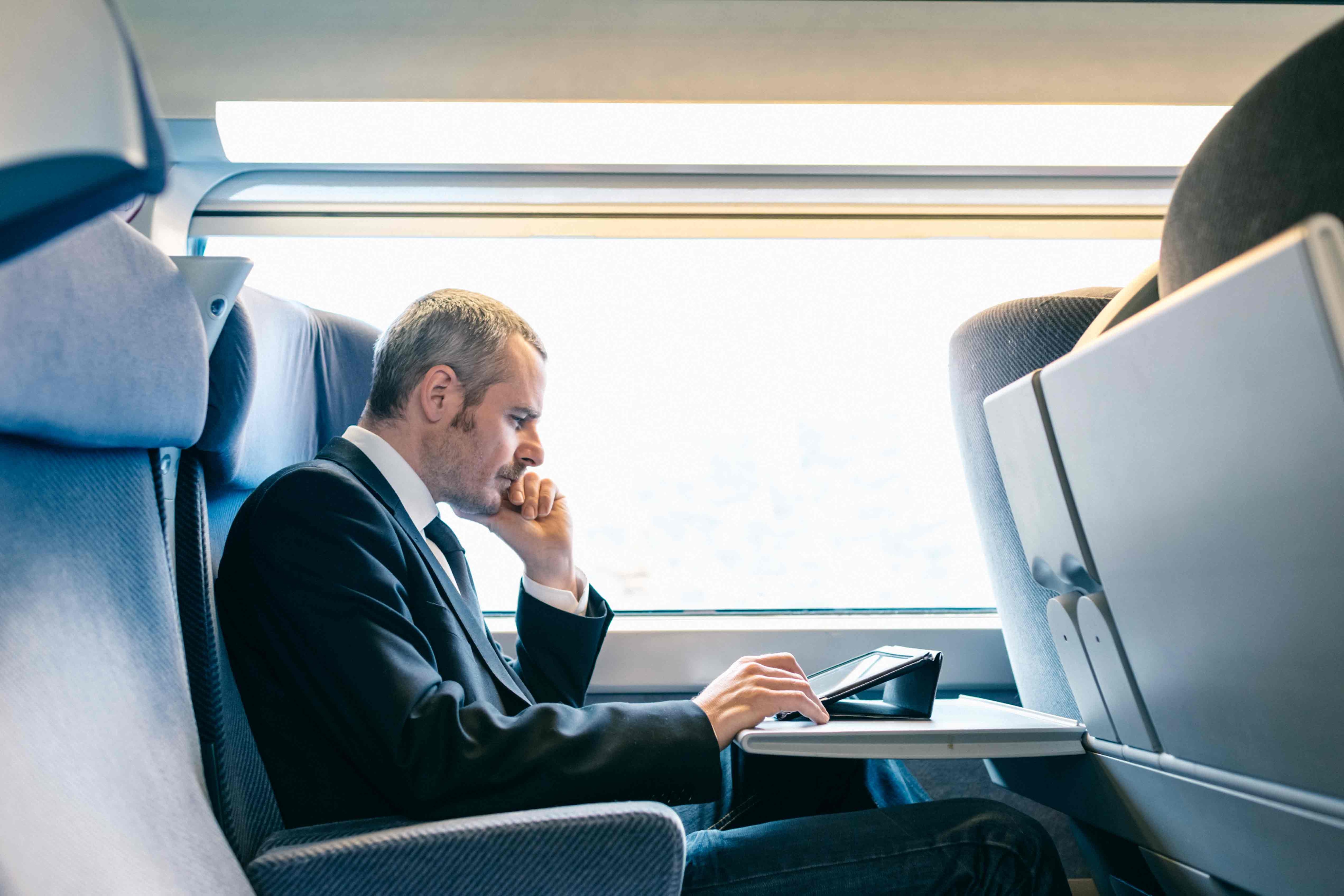 man sitting on train contemplating