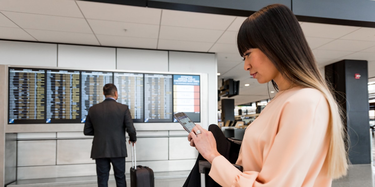 woman at airport looking at phone