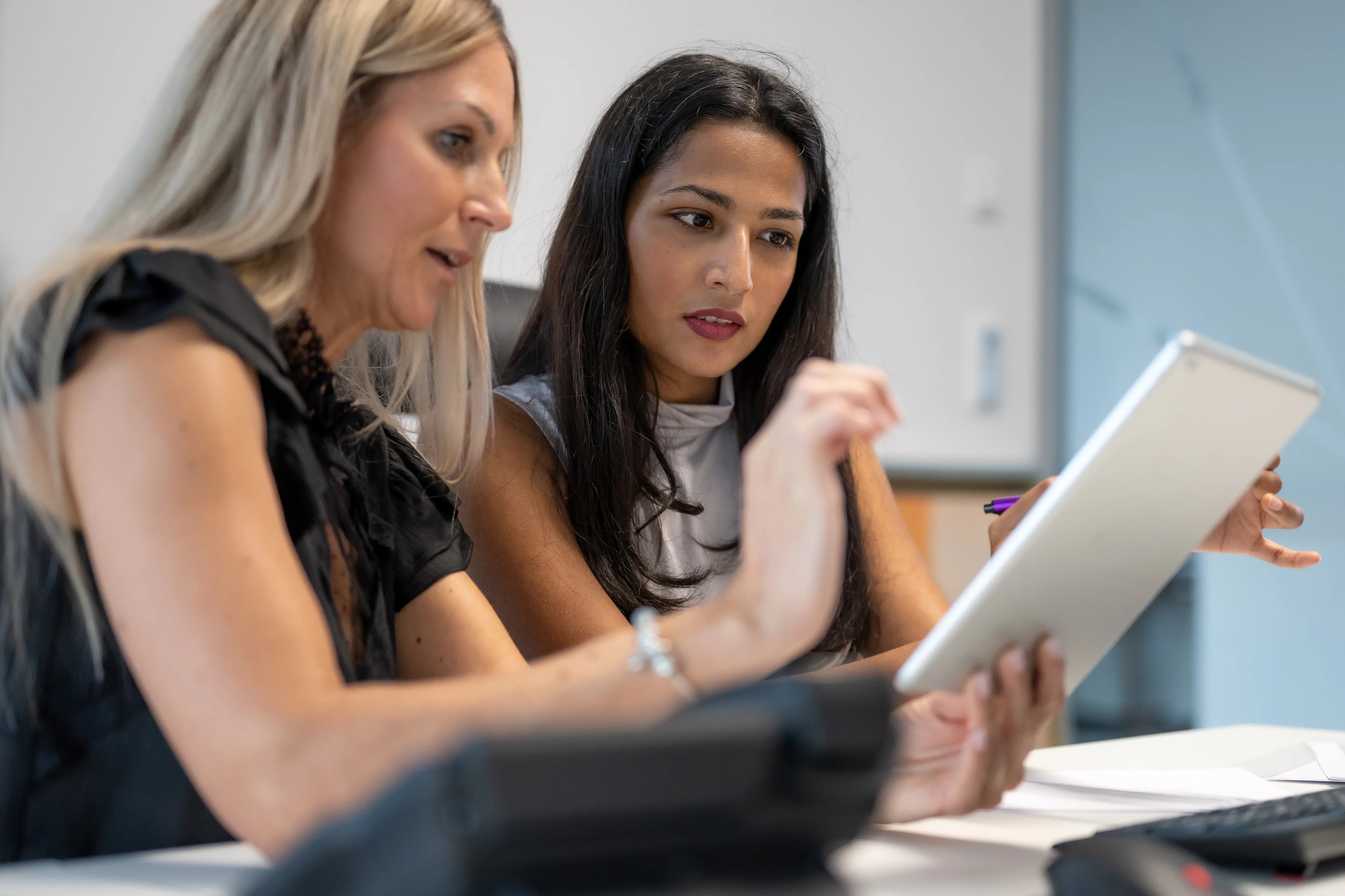 two colleagues working together on laptop