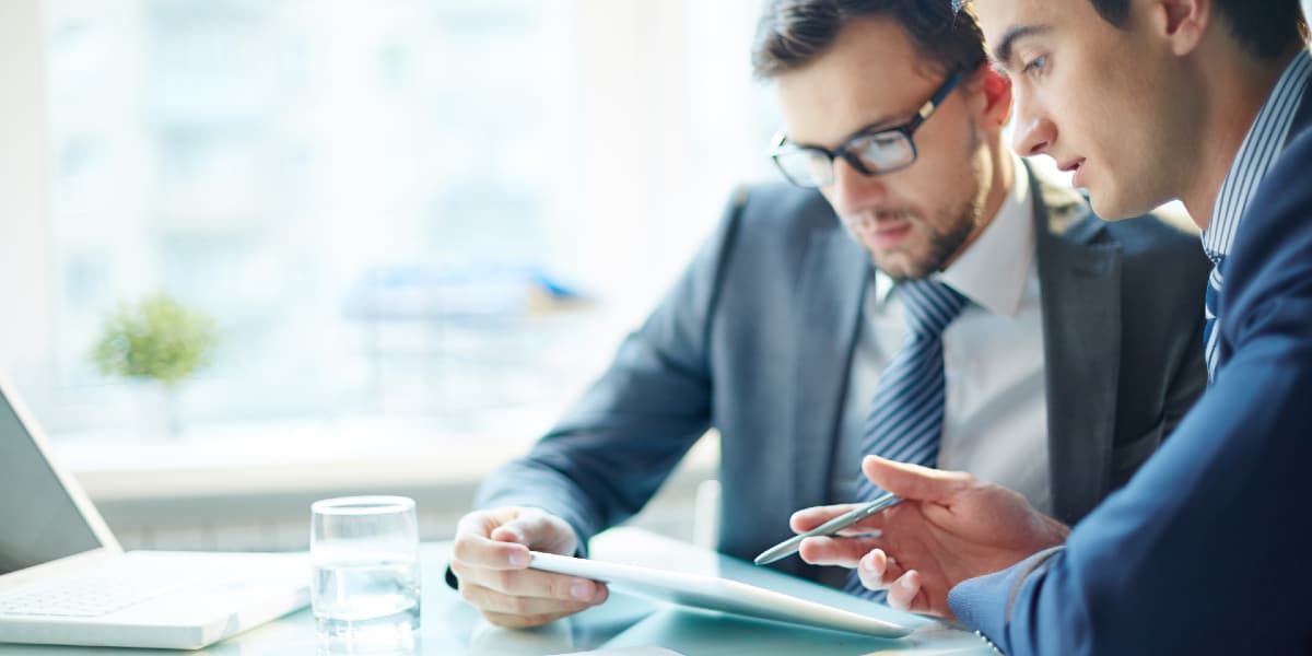 two colleagues working together on tablet