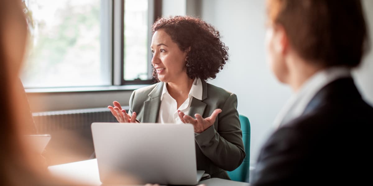 female employees discussing work around table