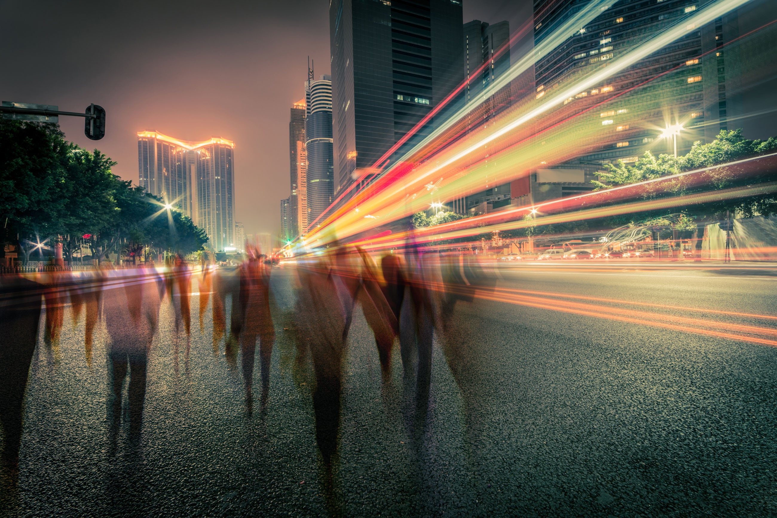 people walking on the street with city lights