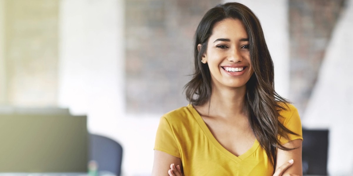 woman smiling with arms folded