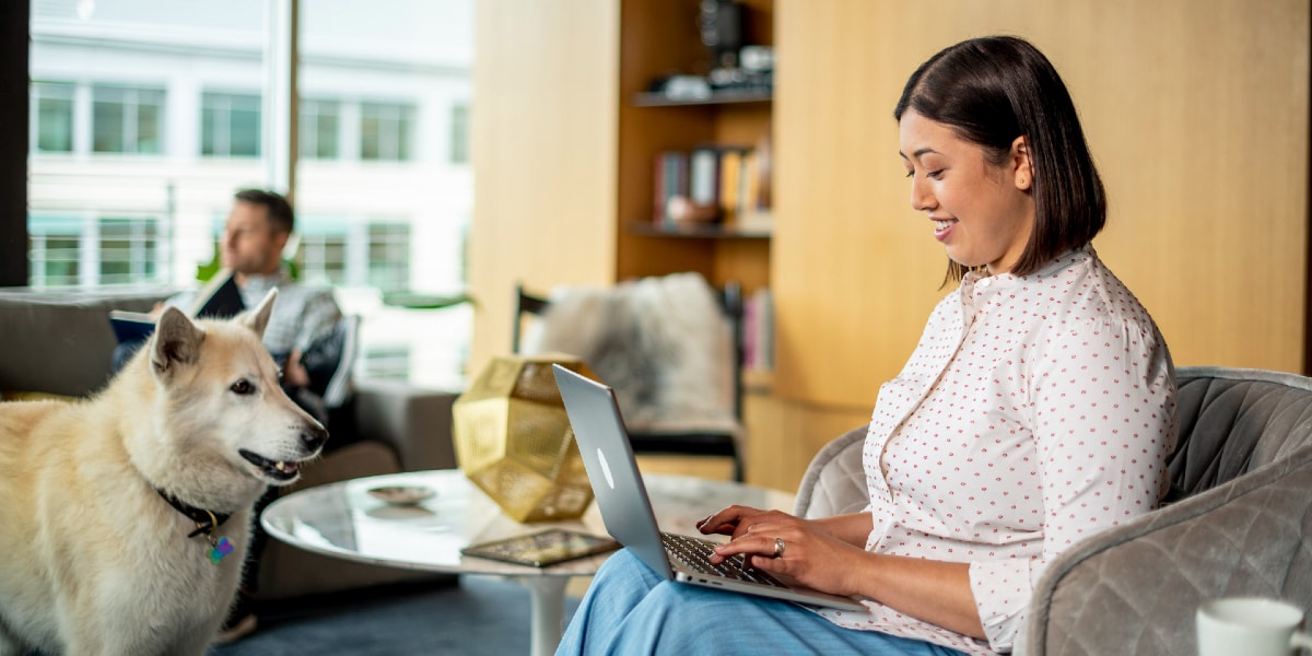 woman working from home with dog